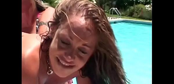  Two sexy young bitches loves to share one massive sex toy by the pool